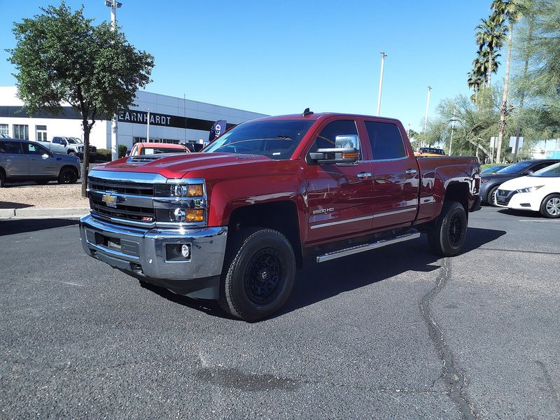 Red Chevrolet Silverado 2500HD pickup parked in a lot