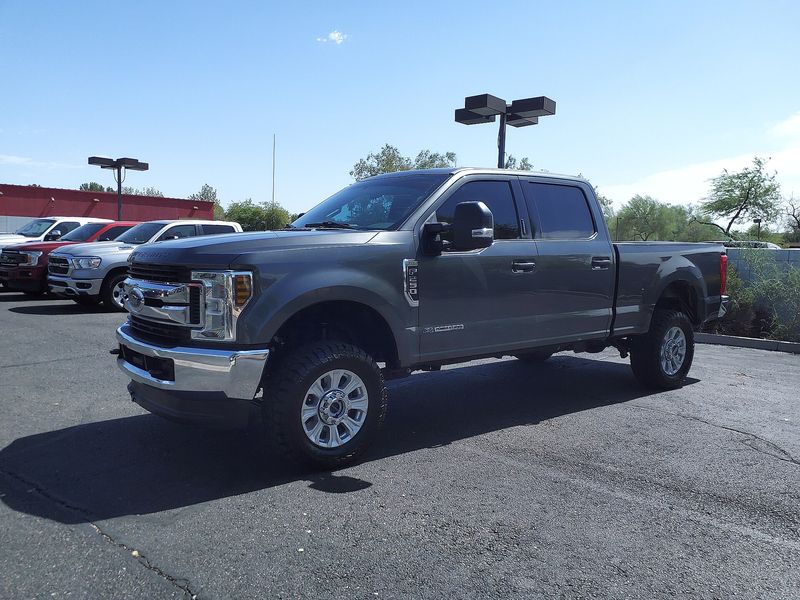 Gray Ford F-250 Super Duty pickup parked in a lot