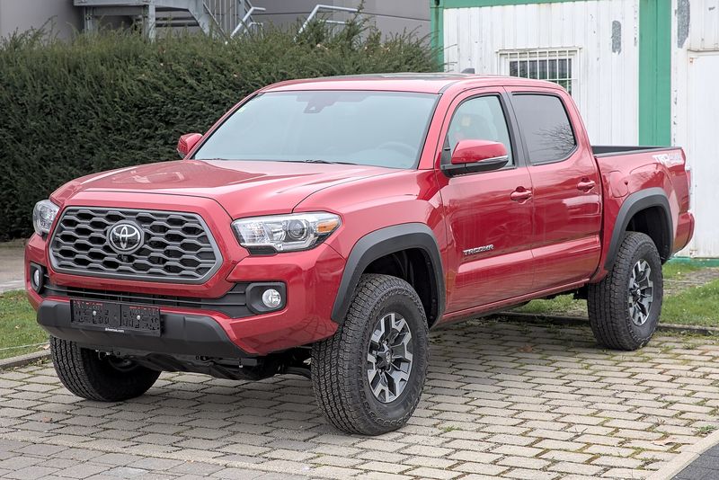 Red Toyota Tacoma TRD pickup, front three-quarter view